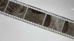 Film strip showing architectural details and concrete structures in black and white.