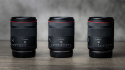 Three Canon RF mount lenses displayed side by side showing 24mm, 35mm, and 50mm focal lengths.