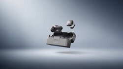 Professional camera equipment and accessories suspended in mid-air against a gradient gray studio backdrop.