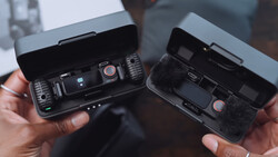 Two drone remote controllers held open side-by-side, displaying their internal components and control layouts.