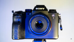 Three vintage and modern cameras arranged in a row against a light background, with a blue Startisan camera in sharp focus in the foreground.