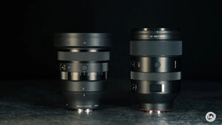 Two vintage camera lenses displayed side by side against a dark background.