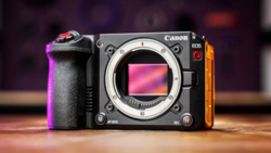 Canon EOS R5 mirrorless camera body displayed against colorful purple and orange gradient lighting.