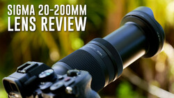 Sigma 20-200mm lens mounted on a DSLR camera body against a blurred green background.