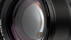 Close-up view of a camera lens showing internal glass elements and optical construction.