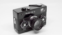 Rollei 35 S compact film camera with black body and textured grip, showing dual manual control dials and fixed lens.