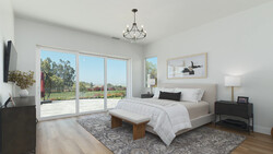 Bright modern bedroom with glass sliding doors opening onto a balcony overlooking landscaped grounds.