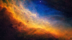 Nebula with fiery orange and golden clouds transitioning to deep blue, dotted with stars.