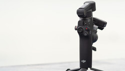 DJI gimbal stabilizer mounted on stand against white background.