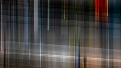 Abstract vertical light streaks and blurred architectural elements with warm and cool color tones.