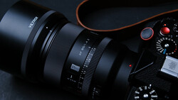 Vitkor zoom lens attached to camera body with orange accents against dark background.
