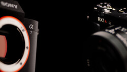 Sony Alpha 7 and RX1R mirrorless cameras positioned against a black background with dramatic side lighting.