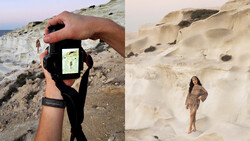 Photographer's hand holding smartphone displaying landscape composition against chalk cliffs and sandy beach.