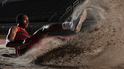 Athlete in boxing gloves sliding across dirt ground, creating a dramatic dust cloud during dynamic movement.