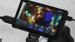 Screenshot of video editing software interface displaying colorful bokeh footage with adjustment panels and timeline controls.