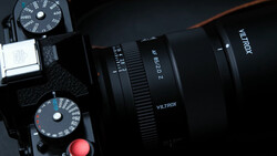 Viltrox lens mounted on camera with exposure dials visible in overhead composition.