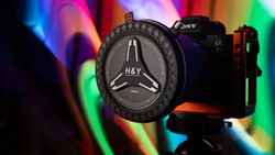 H&Y circular filter holder mounted on Sony mirrorless camera with colorful gradient lighting backdrop.