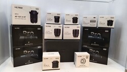 Collection of Viltrox camera lens boxes and packaging displayed on white surface.