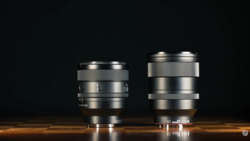 Two silver camera lenses of different sizes positioned side by side against a dark background.
