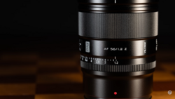 Zeiss AF 56/1.2 Z lens with focus ring and aperture markings visible against dark background.