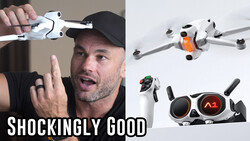 Man holding a compact white drone while gesturing enthusiastically at camera.