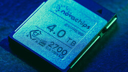 Close-up of a computer processor chip with visible text and specifications under blue-tinted lighting.