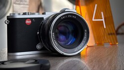 Leica rangefinder camera with Carl Zeiss lens on wooden surface.