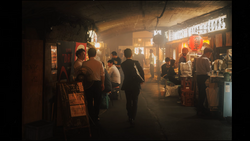 Crowded night market alley with warm golden lighting from shop fronts and lanterns.