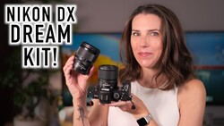 Woman holding a Nikon DX camera body and lens against a colorful blurred background.