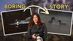 Photographer holding camera standing in front of two wildlife photographs displayed on screens.