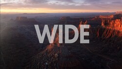 Aerial view of Grand Canyon at sunrise with the word WIDE overlaid in large white text.