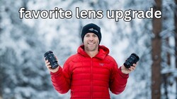 Photographer holding two telephoto lenses in snowy forest setting wearing red jacket.