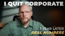 Man in green shirt with glasses looking at camera in indoor office setting.