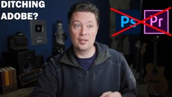Man in dark hoodie speaking to camera with Adobe Creative Suite logos crossed out behind him.