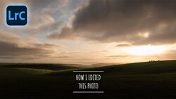 Dramatic landscape at sunset with rolling hills silhouetted against a moody sky with golden and gray clouds.