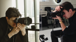 Two photographers in an office setting, each holding professional DSLR cameras with large lenses, one photographing the other.