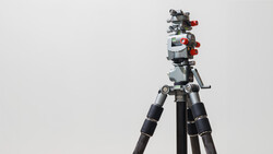 Professional video camera rig mounted on tripod with follow focus system and wireless monitor.