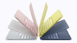 Illustration of five laptop computers arranged in a fan pattern, displaying various pastel colors including pink, white, yellow, and dark blue.