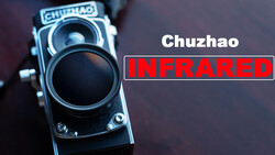 Chuzhao medium-format film camera with infrared lens attachment positioned against a dark background.