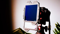 Monitor and camera rig setup on tripod with studio lighting