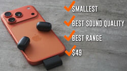 Red smartphone with triple camera setup and three black wireless earbuds displayed against gray surface.