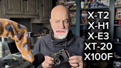 Photographer holding a vintage rangefinder camera with a list of camera models overlaid, marked "WRONG."