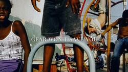 Group of people gathered around playground equipment with overlaid text reading 'GEAR WON'T SAVE YOU.'