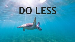 Sea turtle swimming underwater in clear blue ocean with sunlight filtering from above.