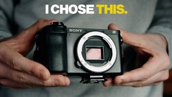 Sony Alpha mirrorless camera body held in hands, showing the sensor and lens mount.