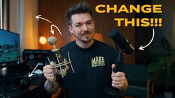 Content creator in studio holding microphone and musical instrument with annotation arrows pointing to equipment.
