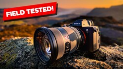 Sony Alpha mirrorless camera with telephoto lens mounted on a rocky outcrop at sunset.