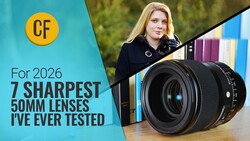 Woman holding a 50mm camera lens with colorful books blurred in the background.