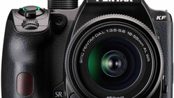 Pentax KF DSLR camera with 18-55mm kit lens on white background
