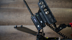 Professional wireless audio transmitter and receiver units mounted on equipment stand